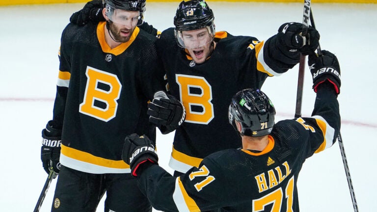 Boston Bruins center Charlie Coyle (13) celebrates with teammates Boston Bruins defenseman Derek Forbort (28) and Boston Bruins left wing Taylor Hall (71) after scoring late in the first period. The Boston Bruins host the Florida Panthers on October 30, 2021 at TD Garden in Boston, MA.