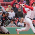 Boston Red Sox Rafael Devers strikes out swinging as Tampa Bay Rays catcher Christian Bethancourt squeezes the ball to end the game during MLB action at Fenway Park.