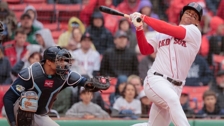 Boston Red Sox Rafael Devers strikes out swinging as Tampa Bay Rays catcher Christian Bethancourt squeezes the ball to end the game during MLB action at Fenway Park.