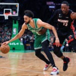 The Celtics Derrick White moves the basketball past the defense of Miami's Bam Adebayo. The Boston Celtics hosted the Miami Heat for Game Seven of their NBA Eastern Conference Championship series at the TD Garden.