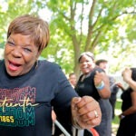 A happy woman celebrates as she comes off the stage in Boston Common