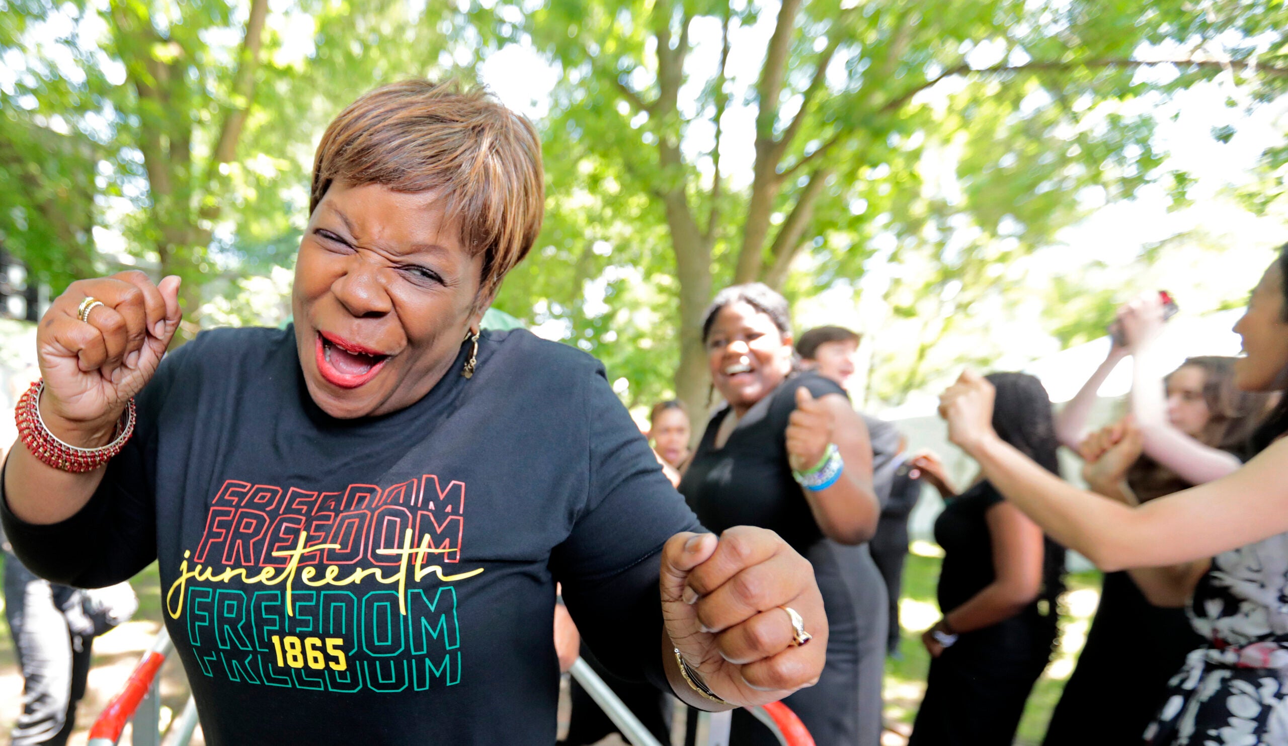 A happy woman celebrates as she comes off the stage in Boston Common