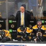 A stunned Bruins bench at the end of the game as they lost in overtime. Coach Jim Montgomery looks on with his dejected players
