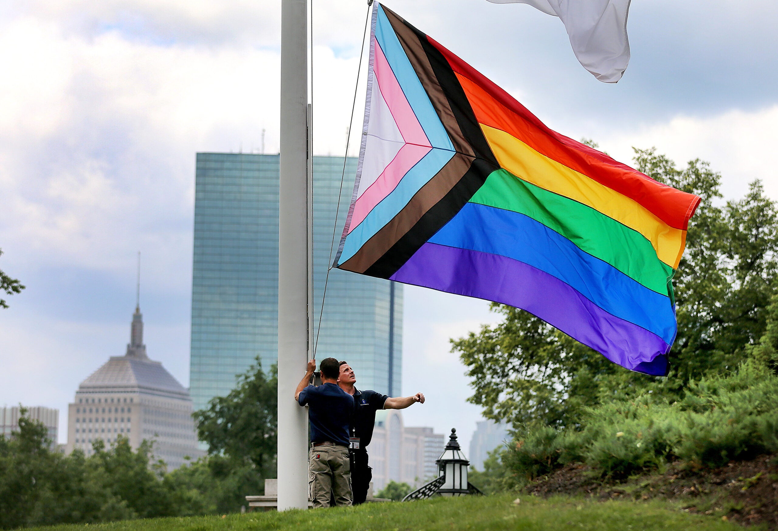 Massachusetts State House workers get set to raise the Pride flag in front of the State House on Wednesday.