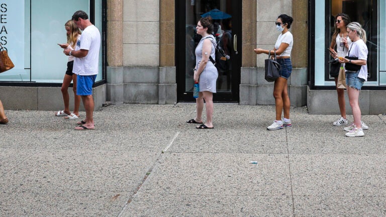 Shoppers wait in line at Zara