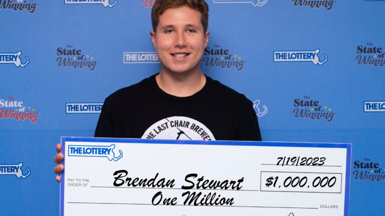 Powerball winner Brendan Stewart holds check for $1 million.