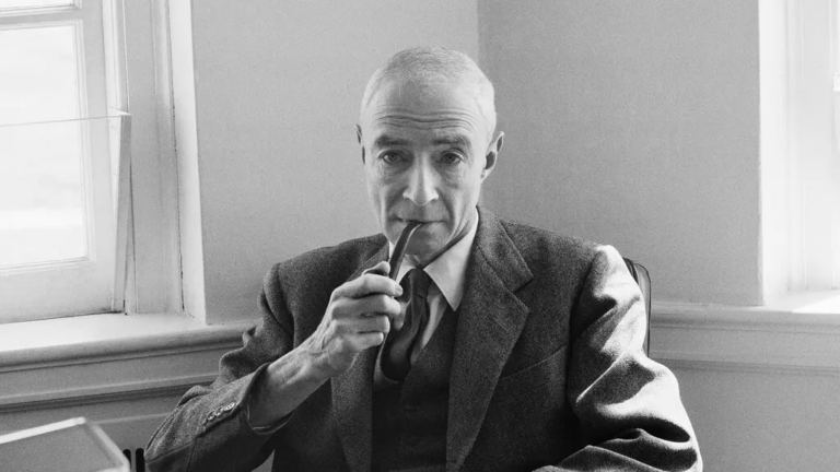Robert J. Oppenheimer smokes from a pipe.