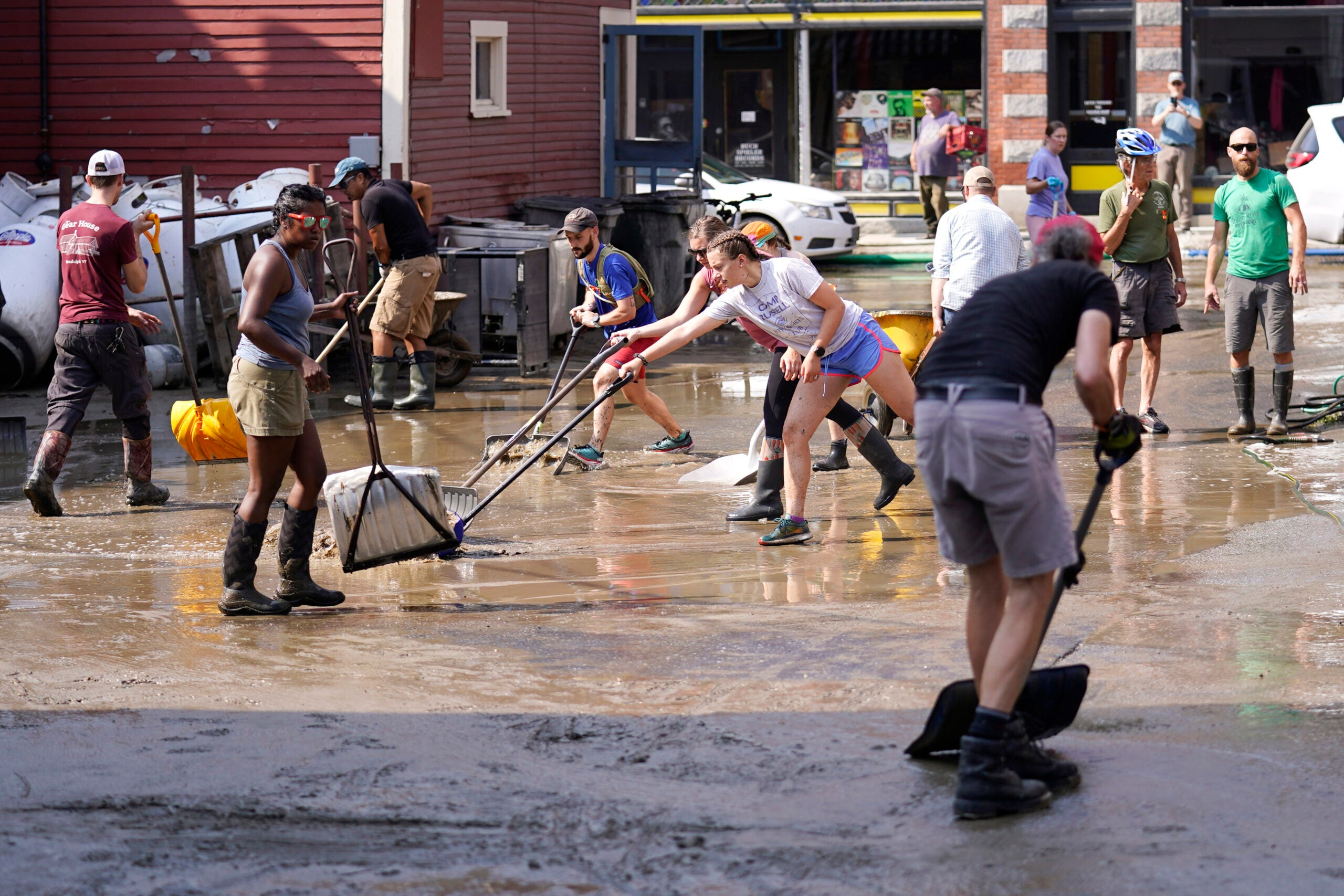 Volunteers clean up a downtown parking area on the banks of the Winooski River.