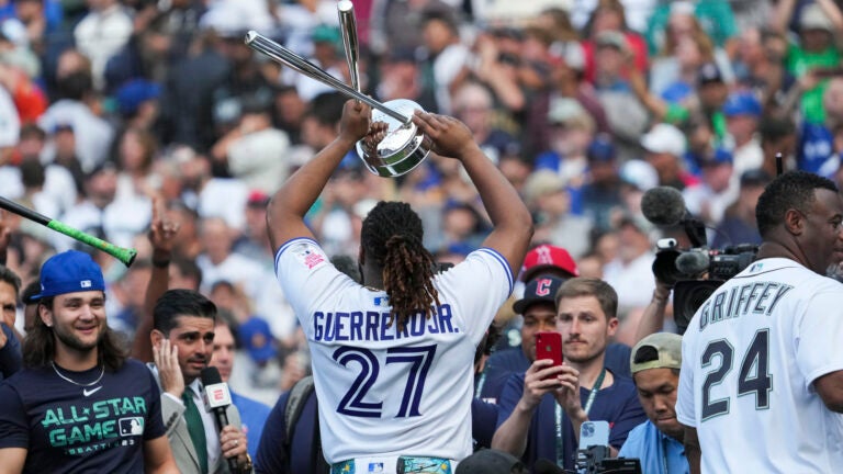 American League's Vladimir Guerrero Jr., of the Toronto Blue Jays, holds up his trophy after winning the MLB All-Star baseball Home Run Derby in Seattle.
