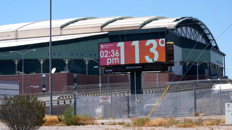A billboard redisplays a temperature of 113 degrees Fahrenheit.