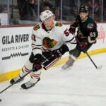 Chicago Blackhawks defenseman Ian Mitchell (51) skates away from Arizona Coyotes left wing Matias Maccelli in the third period during an NHL hockey game, Tuesday, Feb. 28, 2023, in Tempe, Ariz. Arizona won 4-1.
