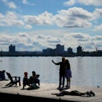 BOSTON, MA - 7/3/2023 People hang out on a dock along the Esplanade in Boston.