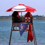 Boston weather --, MA - 7/05/2023: SHADE from an umbrella in a park, beach or even from trees was needed today in the warm July sun around Boston.