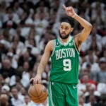 Boston Celtics guard Derrick White (9) gestures during Game 4 of the NBA basketball playoffs Eastern Conference finals against the Miami Heat, Tuesday, May 23, 2023, in Miami.