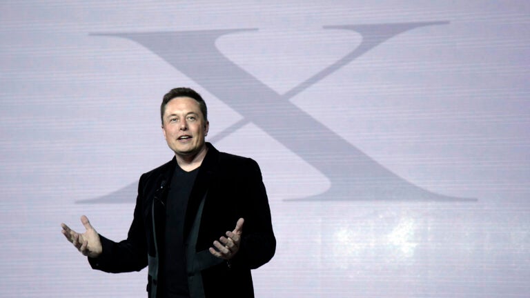 Elon Musk talks at press conference.