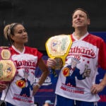This year's woman's champion Miki Sudo, left, and man's champion Joey Chestnut, right, stand together during the 2023 Nathan's Famous Fourth of July hot dog eating contest in the Coney Island section of the Brooklyn borough of New York, Tuesday, July. 4, 2023. (AP Photo/Yuki Iwamura)