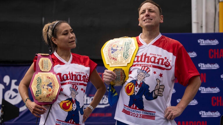This year's woman's champion Miki Sudo, left, and man's champion Joey Chestnut, right, stand together during the 2023 Nathan's Famous Fourth of July hot dog eating contest in the Coney Island section of the Brooklyn borough of New York, Tuesday, July. 4, 2023. (AP Photo/Yuki Iwamura)