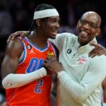 Shai Gilgeous-Alexander #2 of the Oklahoma City Thunder and assistant coach Sam Cassell of the Philadelphia 76ers embrace after the game at the Wells Fargo Center on January 12, 2023 in Philadelphia, Pennsylvania. The 76ers defeated the Thunder 133-114.