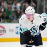 Seattle Kraken center Morgan Geekie watches a face-off against the Dallas Stars during Game 2 of an NHL hockey Stanley Cup second-round playoff series, Thursday, May 4, 2023, in Dallas.
