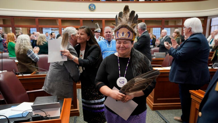 Clarissa Sabattis, Chief of the Houlton Band of Maliseets, foreground, and other leaders of Maine's tribes are welcomed by lawmakers into the House Chamber in Maine.