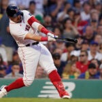 Boston Red Sox's Adam Duvall doubles to left field, allowing Justin Turner to score, in the third inning of a baseball game against the New York Mets, Sunday, July 23, 2023, in Boston.