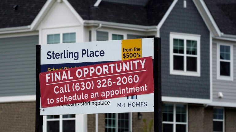 a for sale sign in front of a home is used to illustrate a story on the latest mortgage rates