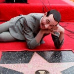 Comedian Pee-wee Herman, whose real name is Paul Reubens, admires his star on the Walk of Fame in Hollywood in this July 20, 1988, file photo.