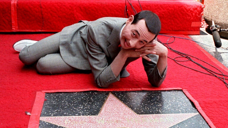 Comedian Pee-wee Herman, whose real name is Paul Reubens, admires his star on the Walk of Fame in Hollywood in this July 20, 1988, file photo.