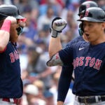 Masataka Yoshida, right, celebrates with Red Sox teammate Justin Turner after hitting a grand slam during the fifth inning