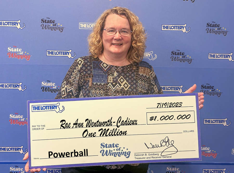 Powerball Winner Rae Ann Wentworth-Cadieux holds $1 million check.
