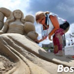 Deborah Barrett-Cutulle works on her sculpture during the Revere Beach International Sand Sculpting Festival.