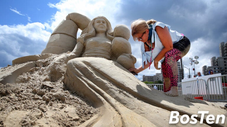Deborah Barrett-Cutulle works on her sculpture during the Revere Beach International Sand Sculpting Festival.