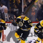 Patrice Bergeron #37, Tyler Seguin #19, and Brad Marchand #63 of the Boston Bruins celebrate following Bergeron's game-winning overtime goal against the Toronto Maple Leafs in Game Seven of the Eastern Conference Quarterfinals during the 2013 NHL Stanley Cup Playoffs on May 13, 2013 at TD Garden in Boston.