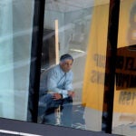 Bruins GM Don Sweeney watches from his office overlooking the ice.