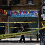 A police officer at the scene of a shooting in Richmond Hill in Queens