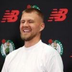 Newly acquired big man Kristaps Porzingis s all smiles after getting gets his new Celtics Jersey at a afternoon press-conference.