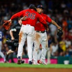 Red Sox first baseman Triston Casas (36) hugs third baseman Rafael Devers (11).
