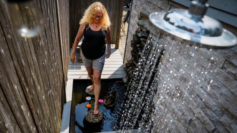 Marti Gruhn, a resident of Barnstable Village, stepped across the goldfish pond in her outdoor shower on Thursday. Gruhn got the inspiration for her shower while visiting the island of Bali in 1996 during a six-month trip around the world.