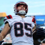 Patriots tight end Hunter Henry (85) is all smiles as he crosses the goal line with a third quarter touchdown pass.