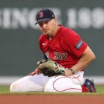 Sox Kike Hernandez is on his knees at shortstop in the 8th inning after he threw the ball wide to first on a single hit by Marlins Jean Segura to ruin Sox pitcher Brayan Bello’s no hitter.