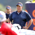 The Patriots held their first workouts at the training camp at Gillette Stadium. Coach Bill Belichick looks over a drill.