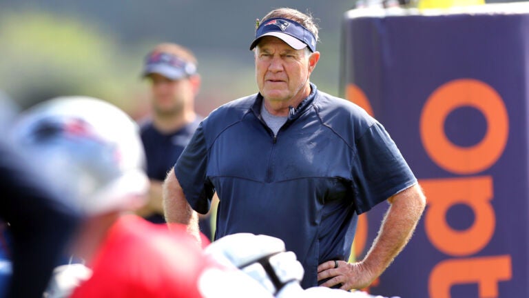 The Patriots held their first workouts at the training camp at Gillette Stadium. Coach Bill Belichick looks over a drill.
