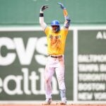Trevor Story celebrates after clubbing one of his three doubles on Sunday.