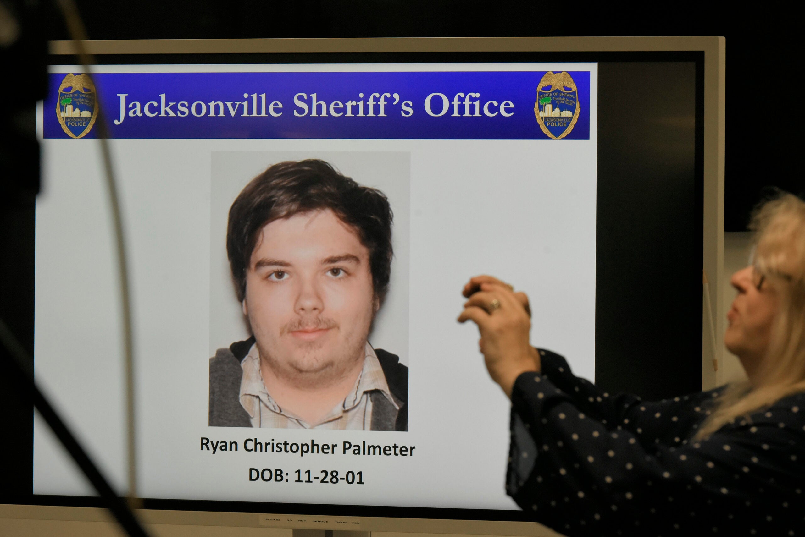 A photograph of shooter Ryan Christopher Palmeter is shown on a video monitor.