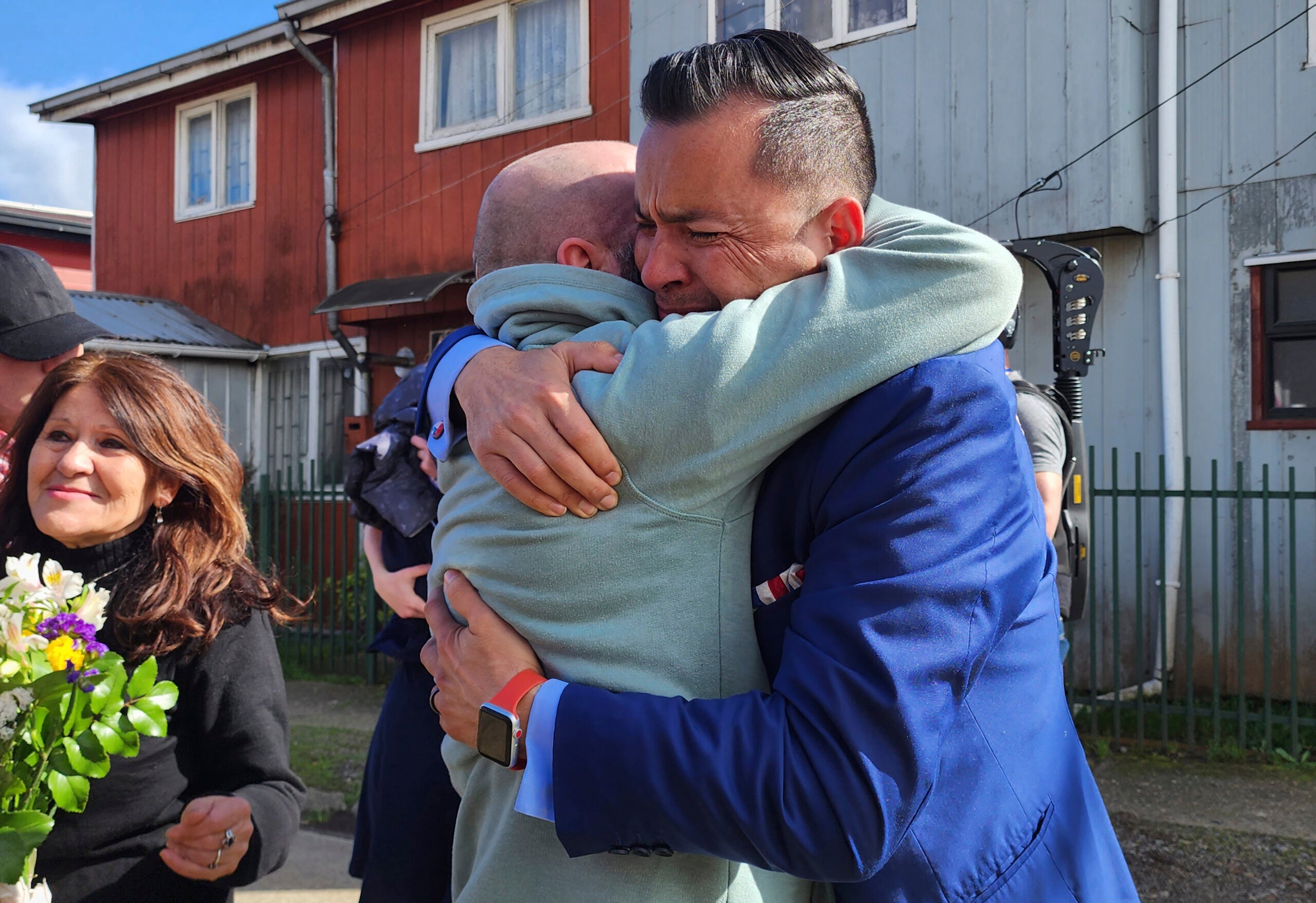 Jimmy Thyden, right, hugs his brother Pablo Leiva Gonzalez as Maria Angelica Gonzalez, his Chilean birth mother, left, looks on.