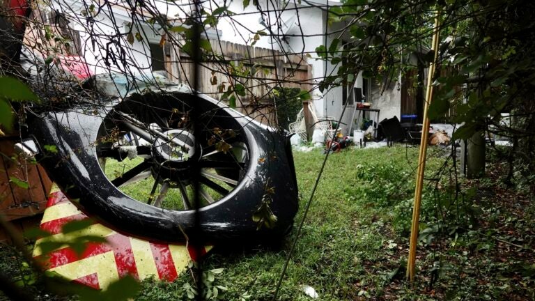 The tail rotor of a Broward Sheriff's Office Fire-Rescue helicopter is seen in the backyard of a home after crashing on Monday, Aug. 28, 2023, near Fort Lauderdale. Fla. (Joe Cavaretta/South Florida Sun-Sentinel via AP)