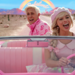 Ryan Gosling and Margot Robbie as Ken and Barbie in a scene from "Barbie." They're driving through a desert in a pink convertible, singing a song.