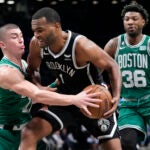 Brooklyn Nets forward T.J. Warren (1) drives against Boston Celtics guard Payton Pritchard, left, and guard Marcus Smart (36) during the second half of an NBA basketball game, Thursday, Jan. 12, 2023, in New York. The Celtics won 109-98.