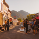A bustling pedestrian street with mountains in the distance