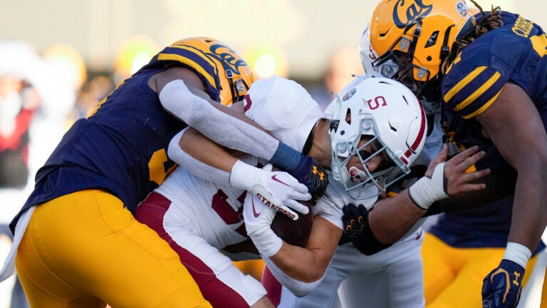 Stanford running back Mitch Leigber, middle, runs the ball against California.